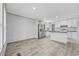 Spacious living room area with light wood flooring, bright lighting, and stainless steel appliances at 1962 Pint Circle, Longs, SC 29568