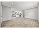An open floor plan features light-colored wood flooring and a modern kitchen with a center island at 1962 Pint Circle, Longs, SC 29568