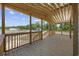 An expansive covered porch with natural wood finish and views of the surrounding landscape at 1962 Pint Circle, Longs, SC 29568