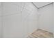 Spacious walk-in closet featuring built-in wire shelving and wood-look flooring at 1962 Pint Circle, Longs, SC 29568