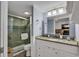 Well-lit bathroom showcases modern vanity with granite countertop and glass-enclosed shower adjacent to toilet at 2001 S Ocean Blvd. # 1504, Myrtle Beach, SC 29577