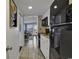 View of efficient kitchen area leading to the living space, bathed in natural light from an outdoor balcony at 2001 S Ocean Blvd. # 1504, Myrtle Beach, SC 29577