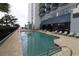 Inviting outdoor pool with lounge chairs, beautiful architecture, and shady spots at 2001 S Ocean Blvd. # 1504, Myrtle Beach, SC 29577