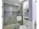 Modern walk-in shower with sleek glass doors and updated fixtures, complemented by nearby storage and toilet at 2001 S Ocean Blvd. # 1504, Myrtle Beach, SC 29577