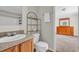 Bright bathroom with a combination shower and tub, vanity, sink, toilet, and towel storage at 203 Warbler St., Georgetown, SC 29440