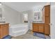 Spacious bathroom featuring a corner bathtub, double vanities, and ample lighting at 203 Warbler St., Georgetown, SC 29440