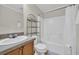 Cozy bathroom with a combination shower and tub, vanity, sink, toilet, and towel storage at 203 Warbler St., Georgetown, SC 29440
