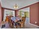 Traditional dining room boasts natural light, a classic chandelier, and direct access to the living area at 203 Warbler St., Georgetown, SC 29440