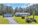 Charming single-story home features a detached garage, white trim and a well-maintained front yard at 203 Warbler St., Georgetown, SC 29440