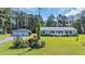 Traditional home with a detached garage offers ample space and curb appeal with a well-manicured lawn at 203 Warbler St., Georgetown, SC 29440
