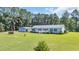 Ranch-style home boasts a manicured lawn, detached garage, and covered front porch, perfect for relaxing at 203 Warbler St., Georgetown, SC 29440