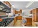 Well-equipped kitchen featuring stainless steel appliances, wooden cabinets, and eat in dining at 203 Warbler St., Georgetown, SC 29440