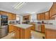 Spacious kitchen equipped with stainless appliances, wood cabinets, and center island at 203 Warbler St., Georgetown, SC 29440