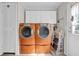 Laundry area offering front loading washer and dryer plus overhead storage at 203 Warbler St., Georgetown, SC 29440