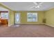 Bright living room boasts neutral carpeting, ceiling fan, and a sunny window with lovely views at 203 Warbler St., Georgetown, SC 29440