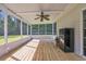 Charming screened porch with wooden flooring, ceiling fan, and views of the backyard at 203 Warbler St., Georgetown, SC 29440