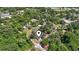 This aerial view of the home is surrounded by lush greenery, revealing its peaceful neighborhood location at 204 Elm St., Johnsonville, SC 29555