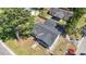 An aerial shot of the home shows the roof and surrounding mature trees; with an unkempt lawn at 204 Elm St., Johnsonville, SC 29555