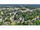 An aerial view shows the home surrounded by lush greenery, revealing its location within a vibrant neighborhood at 204 Elm St., Johnsonville, SC 29555