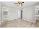 Bright bedroom with light gray walls, fan, and wood-look laminate flooring throughout at 204 Elm St., Johnsonville, SC 29555