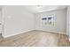 Bright bedroom with wood-look floors, fresh paint, and natural light from the large window at 204 Elm St., Johnsonville, SC 29555