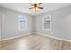Bedroom with wood-look floors, fresh paint, and natural light from the two windows at 204 Elm St., Johnsonville, SC 29555