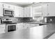 Well lit kitchen with white cabinets, stainless steel appliances, and a granite countertop at 204 Elm St., Johnsonville, SC 29555