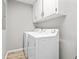 Convenient laundry room featuring modern washer and dryer units and ample cabinet space at 204 Elm St., Johnsonville, SC 29555