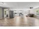 Open-concept layout with wood-look flooring, a kitchen island, and a cozy living area at 204 Elm St., Johnsonville, SC 29555