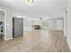 Open floor plan with wood-look floors, fresh paint, and a clear sightline from kitchen to living room at 204 Elm St., Johnsonville, SC 29555