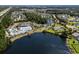Aerial view of a community showcasing a pool, tennis courts, a lake, and other recreational amenities at 205 Threshing Way # 1052, Myrtle Beach, SC 29579