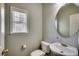 Powder room with oval mirror, window, and neutral paint at 205 Threshing Way # 1052, Myrtle Beach, SC 29579