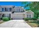 Charming exterior features a two-car garage, fresh paint, and beautiful greenery at 205 Threshing Way # 1052, Myrtle Beach, SC 29579