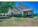 Charming home featuring a screened in porch, well-maintained landscaping, and inviting outdoor space for relaxation at 205 Threshing Way # 1052, Myrtle Beach, SC 29579