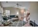 Open-concept living room featuring cozy furniture, natural lighting, and a ceiling fan at 205 Threshing Way # 1052, Myrtle Beach, SC 29579