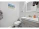 This half bath has a modern vanity, square mirror, beach art and is accented with modern grey tiling at 208 Ocean Blvd. N # 324, North Myrtle Beach, SC 29582