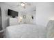 This charming bedroom features a queen bed, a ceiling fan, and a dresser with a television at 208 Ocean Blvd. N # 324, North Myrtle Beach, SC 29582