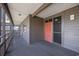 Exterior condo entrance with a red door and views of the outdoor balcony at 208 Ocean Blvd. N # 324, North Myrtle Beach, SC 29582