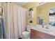 Well-lit bathroom with a single vanity, decorative fish accents, and a shower with a striped curtain at 210 25Th Ave. S # 19, Myrtle Beach, SC 29577