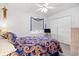 A cozy bedroom with a colorful paisley quilt and white ceiling fan at 210 25Th Ave. S # 19, Myrtle Beach, SC 29577