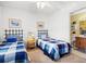 Bright bedroom with twin beds, coastal themed decor and connecting bathroom with a ceiling fan at 210 25Th Ave. S # 19, Myrtle Beach, SC 29577