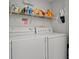 The laundry room has white washer and dryers and metal shelving at 210 25Th Ave. S # 19, Myrtle Beach, SC 29577