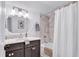 Bathroom featuring modern vanity with mirror, bathtub, a shower with marble-look tile, and updated fixtures at 2150 North Berwick Dr., Myrtle Beach, SC 29575