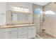 Bright bathroom with double sinks, granite countertops, shower, and decorative mirrors creating a spa-like retreat at 2150 North Berwick Dr., Myrtle Beach, SC 29575