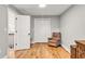Cozy bedroom with hardwood floors, a recliner chair, storage closet, and access to other parts of the house at 2150 North Berwick Dr., Myrtle Beach, SC 29575