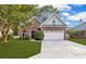 Charming two-story brick home with manicured lawn and attached two-car garage at 2150 North Berwick Dr., Myrtle Beach, SC 29575