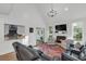 Open living room area with fireplace, chandelier, and view to kitchen at 2150 North Berwick Dr., Myrtle Beach, SC 29575