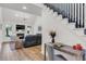 Bright living room featuring fireplace, vaulted ceiling, and staircase with dark railings at 2150 North Berwick Dr., Myrtle Beach, SC 29575
