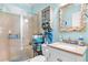 Charming bathroom with custom seashell mirror, stone countertop, and tiled shower at 230 Addison Cottage Way, Murrells Inlet, SC 29576