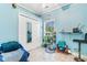 Bright bedroom with white closet doors, a plant shelf, and a comfortable chair at 230 Addison Cottage Way, Murrells Inlet, SC 29576